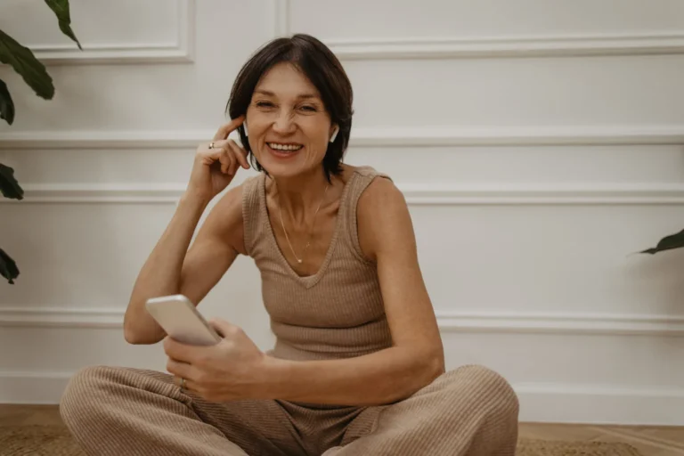 smiling adult caucasian woman enjoys ordering weekend goods phone app online shopping concept
